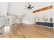 Open concept living room featuring hardwood floors, high ceilings, and a modern kitchen with island seating at 1904 S Union Pl, Lakewood, CO 80228