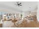 Bright living room with hardwood floors, large windows, a ceiling fan, and an adjacent dining area at 1904 S Union Pl, Lakewood, CO 80228