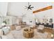 Open concept living space with hardwood floors, high ceilings, ceiling fan, and adjacent kitchen and dining area at 1904 S Union Pl, Lakewood, CO 80228