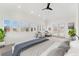 Bright main bedroom with a ceiling fan, with multiple windows and doors providing ample natural light at 1904 S Union Pl, Lakewood, CO 80228
