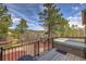 Backyard showing a deck with hot tub and barbecue, along with pine trees, landscape, and mountain views at 3640 Summertime Ct, Monument, CO 80132