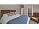Comfortable bedroom featuring a wicker headboard, stylish pillows, and chair; with a closet and doorway viewable at 3640 Summertime Ct, Monument, CO 80132