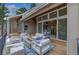 Relaxing covered porch features ample seating and string lights with easy access into the home at 3640 Summertime Ct, Monument, CO 80132
