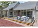 Inviting covered porch features comfortable seating, a red door, and stylish lighting at 3640 Summertime Ct, Monument, CO 80132