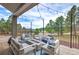 Well-decorated covered porch with a fire pit and comfortable outdoor seating with amazing views at 3640 Summertime Ct, Monument, CO 80132