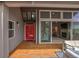 The covered porch offers easy access to the home's interior, featuring a unique red door at 3640 Summertime Ct, Monument, CO 80132