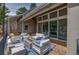 Relaxing covered porch offers ample seating with a fire pit and string lights at 3640 Summertime Ct, Monument, CO 80132