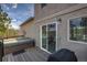 Exterior view of a deck with a covered hot tub, sliding glass doors, and a view of surrounding greenery at 3640 Summertime Ct, Monument, CO 80132
