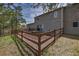 Home exterior showing a fenced backyard with deck, hot tub, barbecue, gravel, mulch, and landscaping at 3640 Summertime Ct, Monument, CO 80132
