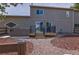 Home exterior view showing a deck with barbecue and hot tub, gravel, mulch, and backyard fencing at 3640 Summertime Ct, Monument, CO 80132
