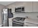 Gourmet kitchen featuring stainless steel appliances, a gas range and quartz countertops at 3640 Summertime Ct, Monument, CO 80132