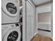 Convenient laundry area with stacked washer and dryer, as well as extra storage shelves at 3640 Summertime Ct, Monument, CO 80132