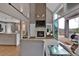 Open-concept living room with a stone fireplace and sliding doors to the porch at 3640 Summertime Ct, Monument, CO 80132