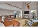 Open-concept living room featuring high ceilings, comfortable seating, and a rustic decor at 3640 Summertime Ct, Monument, CO 80132