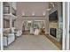 Bright and open living room with fireplace, connecting seamlessly to the kitchen and dining area at 3640 Summertime Ct, Monument, CO 80132