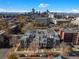 Aerial view of new townhome construction with Denver skyline in the background at 1735 E 18Th Ave, Denver, CO 80218