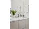 Modern bathroom with double sinks, white countertop and cabinetry, and chrome fixtures at 1735 E 18Th Ave, Denver, CO 80218