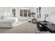 Bright bedroom featuring a modern desk and chair, a comfortable armchair, and an oversized window at 1735 E 18Th Ave, Denver, CO 80218