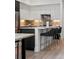 Open kitchen featuring a large island with seating, sleek cabinets, modern appliances, and stylish decor at 1735 E 18Th Ave, Denver, CO 80218