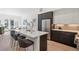 Open concept kitchen and living room with a large island, stainless steel appliances, and modern decor at 1735 E 18Th Ave, Denver, CO 80218