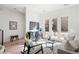 Bright living room with modern decor, large windows, comfortable seating, and stylish geometric rug at 1735 E 18Th Ave, Denver, CO 80218