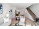 Open-concept living room with modern furnishings, staircase, and a view into the stylish kitchen at 1735 E 18Th Ave, Denver, CO 80218