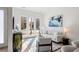 Sunlit living room with contemporary furnishings, glass doors to a balcony, and modern artwork at 1735 E 18Th Ave, Denver, CO 80218