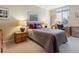 Comfortable bedroom with a cozy bed, lamps, a desk, and a window providing natural light at 1111 Race St # 3A, Denver, CO 80206