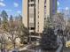 View of the exterior of the building, with tall trees surrounding the property at 1111 Race St # 3A, Denver, CO 80206