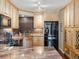 Bright kitchen features granite countertops, tile backsplash, wood floors and cabinets, and stainless steel appliances at 1111 Race St # 3A, Denver, CO 80206