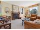 Living room with large windows and a cozy fireplace at 1111 Race St # 3A, Denver, CO 80206
