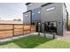 View of a spacious backyard featuring a modern fence and fresh lawn with pavers at 4481 Raleigh St, Denver, CO 80211