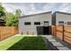 Backyard showing a modern fence, pavers and fresh lawn with a clean, stylish finish at 4481 Raleigh St, Denver, CO 80211