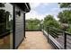 Spacious outdoor balcony with wood-look tile flooring and black metal railings, perfect for relaxing at 4481 Raleigh St, Denver, CO 80211