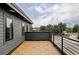 Open-air balcony with wood-look tile flooring, black railings and exterior view at 4481 Raleigh St, Denver, CO 80211