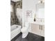 Modern bathroom features a tub-shower with tile surround, sleek fixtures, and a stylish vanity with marble floors at 4481 Raleigh St, Denver, CO 80211