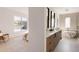 Bright bathroom featuring dual vanities, mirrors, and a sleek soaking tub next to a sunlit window at 4481 Raleigh St, Denver, CO 80211