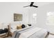 Bedroom with minimalist decor, neutral bedding, and two windows for lots of natural light at 4481 Raleigh St, Denver, CO 80211