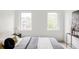 Neutral bedroom featuring minimalist decor and natural lighting through two windows at 4481 Raleigh St, Denver, CO 80211