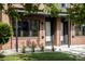 Close up of the exterior of a brick townhome with modern black window accents at 4481 Raleigh St, Denver, CO 80211