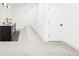 Hallway with dark wet bar with black cabinets, light gray floors, and white trim at 4481 Raleigh St, Denver, CO 80211