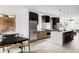 Modern kitchen featuring an island with seating, stainless steel appliances, and light hardwood floors at 4481 Raleigh St, Denver, CO 80211