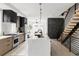 Contemporary kitchen with a large island, stainless steel appliances, and open staircase design at 4481 Raleigh St, Denver, CO 80211