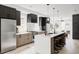 Bright modern kitchen features a marble island, stainless steel appliances and a decorative range hood at 4481 Raleigh St, Denver, CO 80211