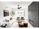 Cozy living room with a modern fireplace, white sofa, and natural light from large windows at 4481 Raleigh St, Denver, CO 80211