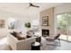 Bright living room with a fireplace, large windows, and stylish modern decor at 4481 Raleigh St, Denver, CO 80211