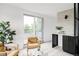 Bright living room with modern furniture, a sliding glass door to the balcony, and natural light at 4481 Raleigh St, Denver, CO 80211