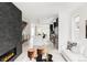 Open-concept living room and kitchen with hardwood floors, fireplace, and stylish furniture at 4481 Raleigh St, Denver, CO 80211