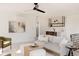 Open living room featuring modern furniture, ceiling fan, with wet bar and artwork at 4481 Raleigh St, Denver, CO 80211