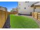 Well-maintained backyard featuring low maintenance synthetic grass and wood fencing for added privacy at 18366 E 102Nd Pl, Commerce City, CO 80022
